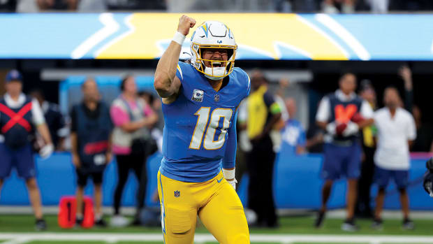Los Angeles Chargers quarterback Justin Herbert (10) reacts after throwing a touchdown pass during the first quarter against the Dallas Cowboys at SoFi Stadium.
